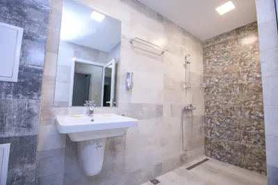 a bathroom with a sink and a shower at Apartments KiM Sandanski in Sandanski