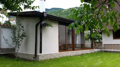 a house with windows on the side of it at Kavdanski Guesthouse in Sapareva Banya