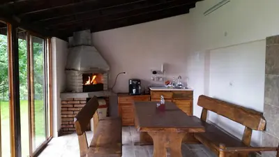 a kitchen with a wooden table and an oven at Kavdanski Guesthouse in Sapareva Banya