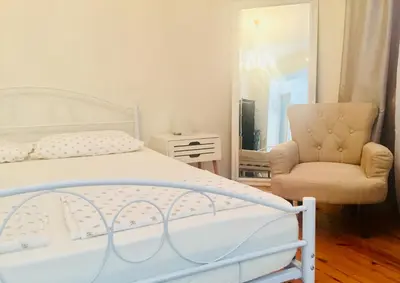 a bedroom with a bed and a chair at CityCentre Gem with Free Parking in Plovdiv