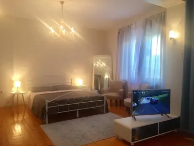 a bedroom with a bed and a tv in it at CityCentre Gem with Free Parking in Plovdiv