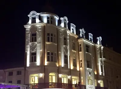 a large white building with lights on it at night at CityCentre Gem with Free Parking in Plovdiv