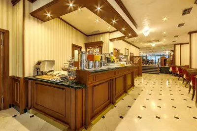 a restaurant with a counter in a room at Hotel COOP, Sofia in Sofia