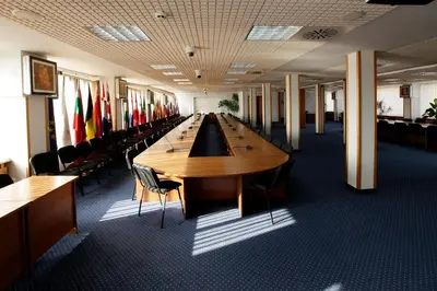 a long row of tables in a room with chairs at Hotel COOP, Sofia in Sofia