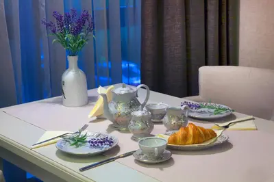 a table with plates of food and cups and croissants at VIKO Boutique Apart Hotel in Sofia