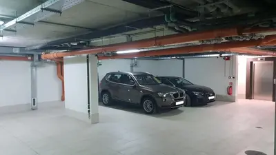 two cars are parked in a parking garage at VIKO Boutique Apart Hotel in Sofia