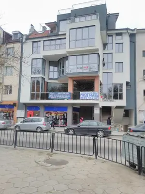 a building with cars parked in front of it at Vila Nova in Sandanski