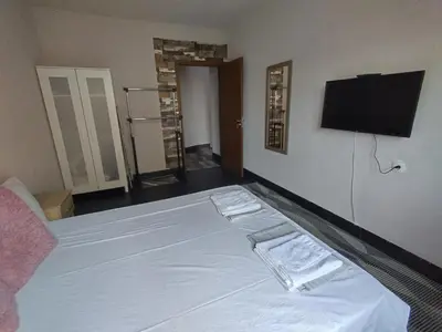 a bedroom with a white bed with two towels on it at Vila Nova in Sandanski