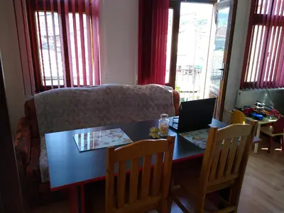 a living room with a table with a laptop on it at Guest House - Batak in Batak