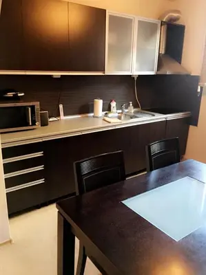 a kitchen with a table and a counter top at Guest House Pautalya in Kyustendil