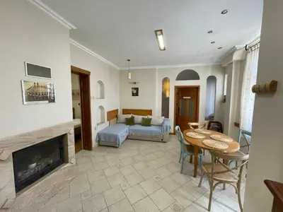 a living room with a fireplace and a couch at Time Traveling Apartment Sofia City in Sofia