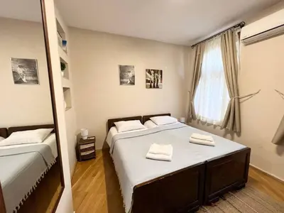 a bedroom with two beds and a window at Time Traveling Apartment Sofia City in Sofia
