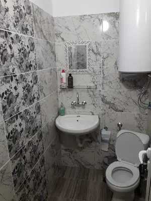 a bathroom with a toilet and a sink at Rooms Lagat in Troyan