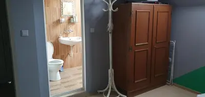 a bathroom with a toilet and a sink next to a door at Rooms Lagat in Troyan