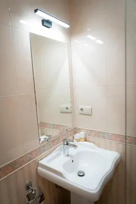 a bathroom with a sink and a mirror at Family Hotel Pak Tam in Karlovo