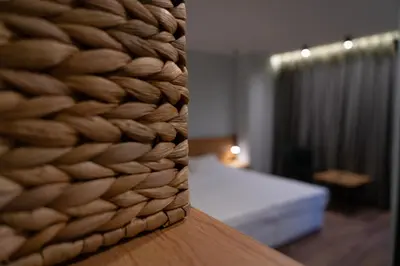 a close up of a wall with a bed in a room at Family Hotel Pak Tam in Karlovo