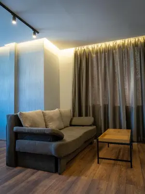 a living room with a couch and a table at Family Hotel Pak Tam in Karlovo