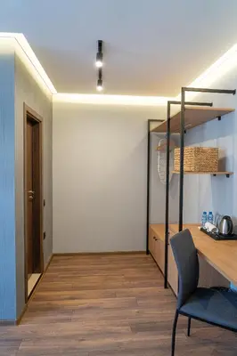 a room with a desk and a table and a chair at Family Hotel Pak Tam in Karlovo