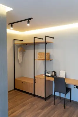 a room with a desk and a table and a chair at Family Hotel Pak Tam in Karlovo