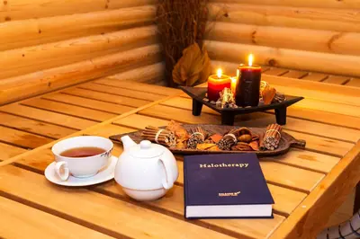 a tray of cookies and candles and a cup of tea at Balneo Complex & Spa Aquatonik in Velingrad