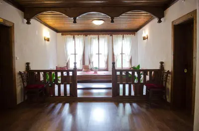 a living room with wooden floors and windows at Petko Takov's House in Smolyan