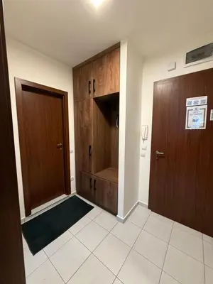 a hallway with two wooden doors in a room at PM Services Borovets Garden Apartments in Borovets