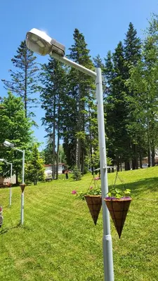 a street light with two flower baskets on it at PM Services Borovets Garden Apartments in Borovets