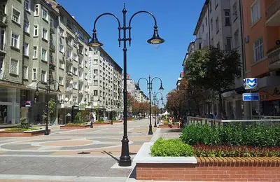 a city street with street lights and buildings at Yavor Apartment in Sofia