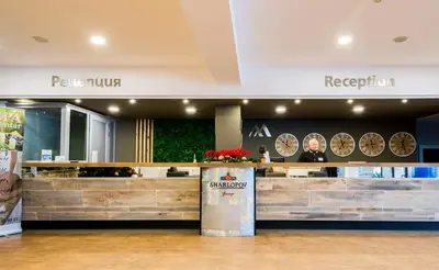 a restaurant with a counter in a building at Grand Hotel Murgavets in Pamporovo