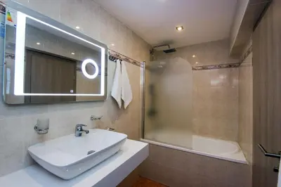 a bathroom with a sink and a shower and a mirror at Devin Spa Hotel in Devin