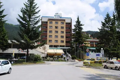 a large building with cars parked in a parking lot at Devin Spa Hotel in Devin