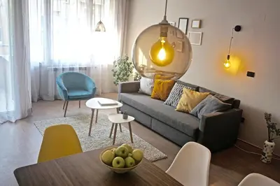 a living room with a couch and a table at Sofia City Home in Sofia