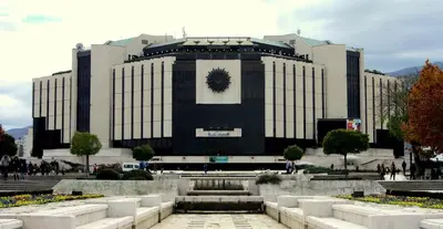 a large building with a fountain in front of it at Sofia City Home in Sofia