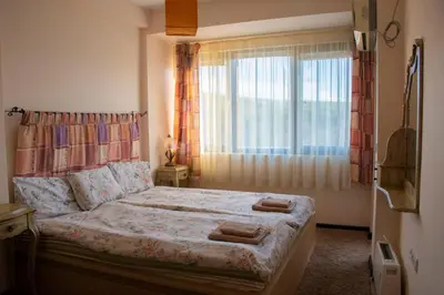 a bedroom with a bed with a large window at Ma-Bebe SPA Suite - Thermal Jacuzzi and Family Comfort in Pchelin