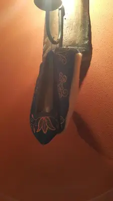 a bag hanging from a light on a wall at Guest House Maria in Koprivshtitsa