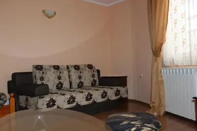 a living room with a couch and a table at Guest House Maria in Koprivshtitsa