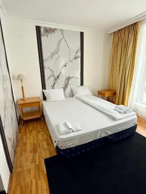 a bedroom with a large bed in a room at Hotel Consul in Sofia