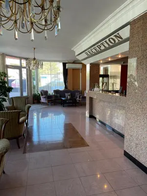 a lobby of a hotel with a chandelier at Hotel Consul in Sofia