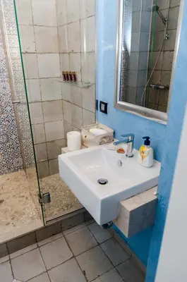 a bathroom with a white sink and a shower at VIP Apartments Sofia in Sofia