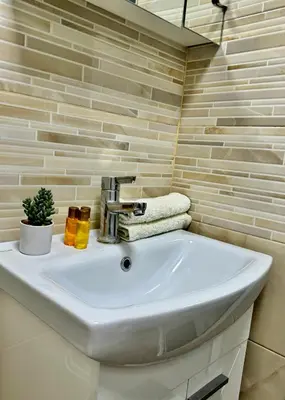 a bathroom with a white sink in a room at Apartment Alex in Sandanski
