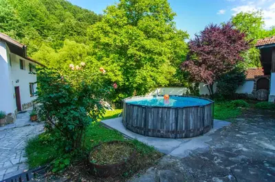 a hot tub in the yard of a house at Guest House Planinska Sreshta in Balkanets