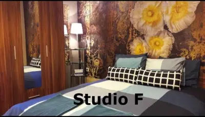 a bedroom with a bed with a flower wall at Studio M in Plovdiv