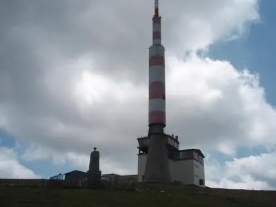 a lighthouse on top of a hill with a sky at Georgievi Guest House in Kalofer