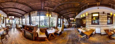 a large room with tables and chairs in a building at Momini Dvori Boutique Guest House in Bansko