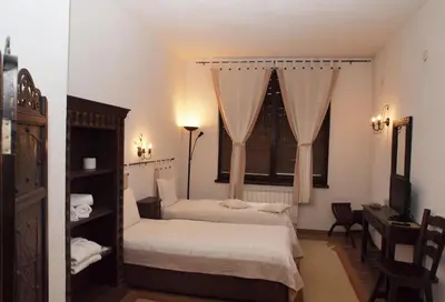 a bedroom with two beds and a window at Momini Dvori Boutique Guest House in Bansko