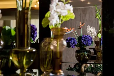 a group of vases filled with flowers on a table at Park Hotel Sankt Peterburg in Plovdiv
