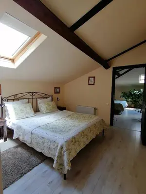 a bedroom with a bed with a white bedspread at Guest House Verbena in Apriltsi