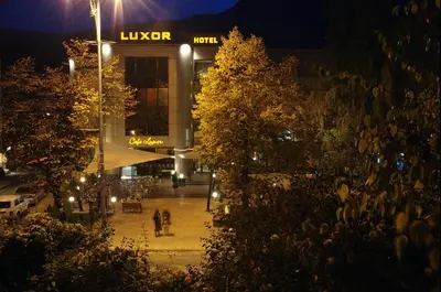 a building at night with people walking in front of it at Luxor Hotel in Smolyan