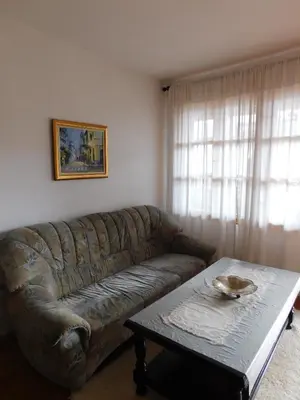 a living room with a leather couch and a coffee table at Family Vacation Home Topolnitza in Koprivshtitsa