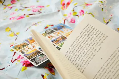 an open book on a bed with flowers at Architectural City Loft in Sofia